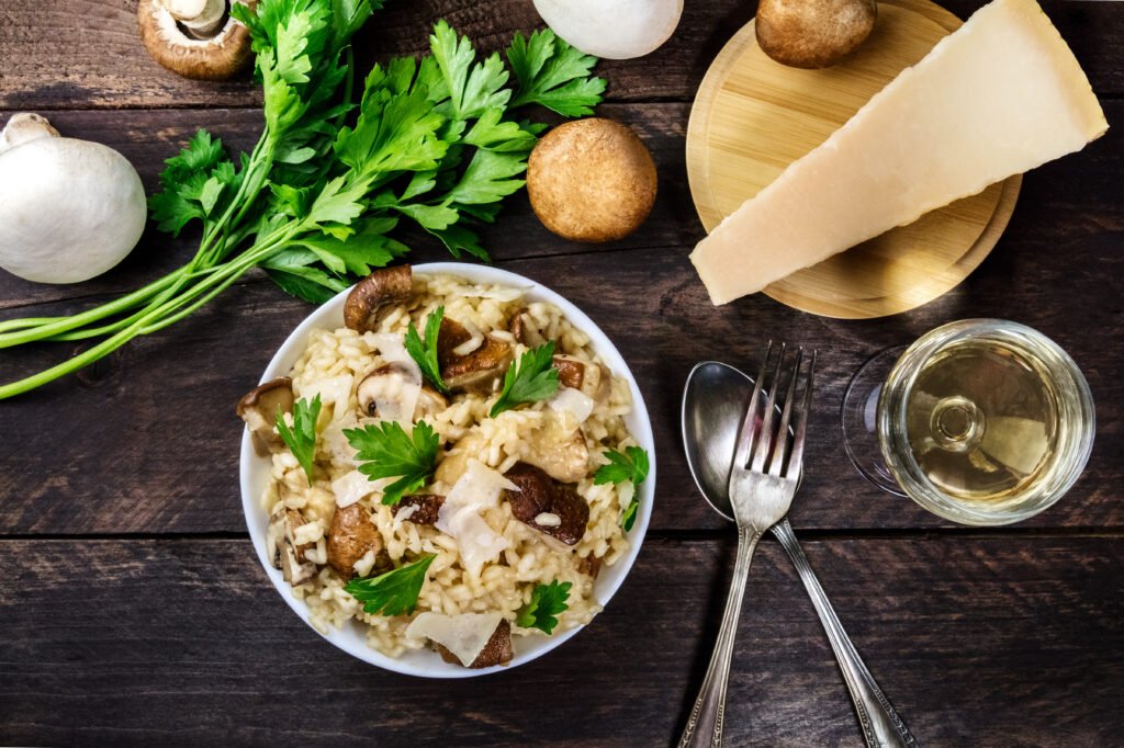 overhead photo of mushroom risotto with ingredients and copyspac